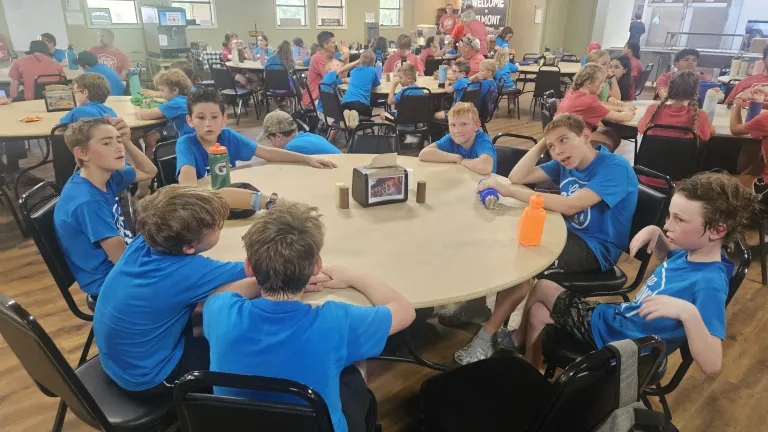 a group of boys sitting around a table