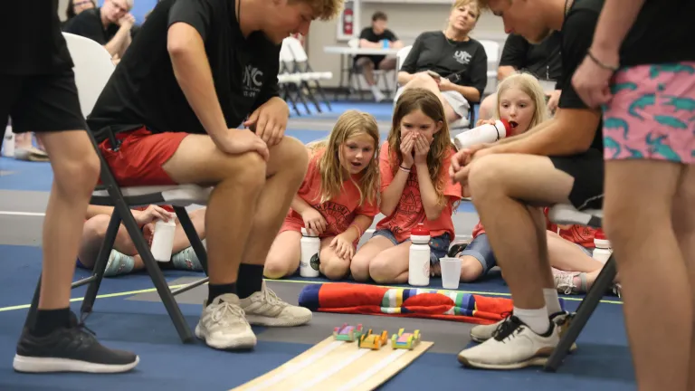 Three girls racing wooden cars