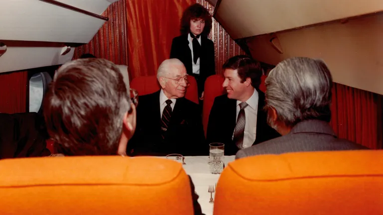 four people inside an old fashioned airplane