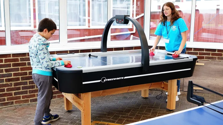 UYC British Isles two children playing at a foosball table