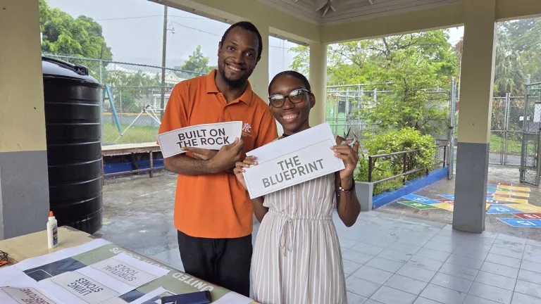 a boy and a girl holding signs