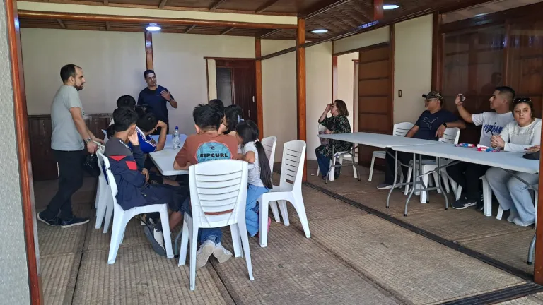 people sitting in white chairs indoors