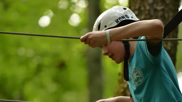 a boy completing a ropes challenge
