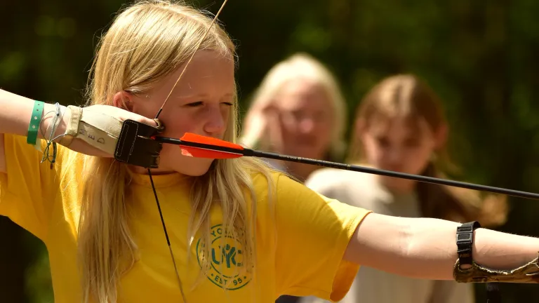 a girl shooting an arrow