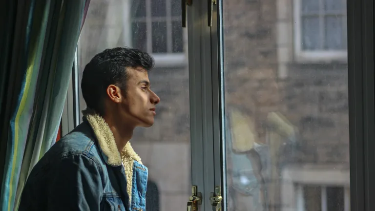 a man looking out a window