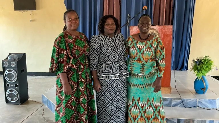 three women standing indoors