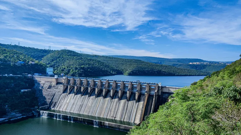 a dam under a blue and cloudy sky