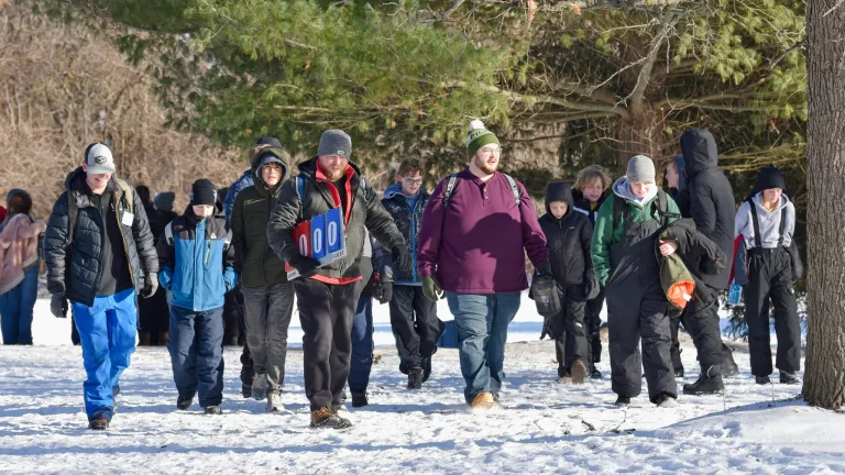 a group of young people walking in the snow