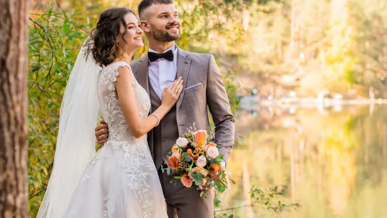 God designed marriage and family to be special. a man and a woman in wedding attire outdoors with a lake in the background