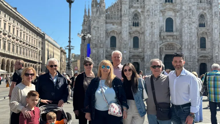a group of people standing in front of a historical building