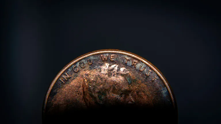 The Bible gives us the blessing of knowing that high-risk strategies just aren’t necessary. a penny against a dark backdrop