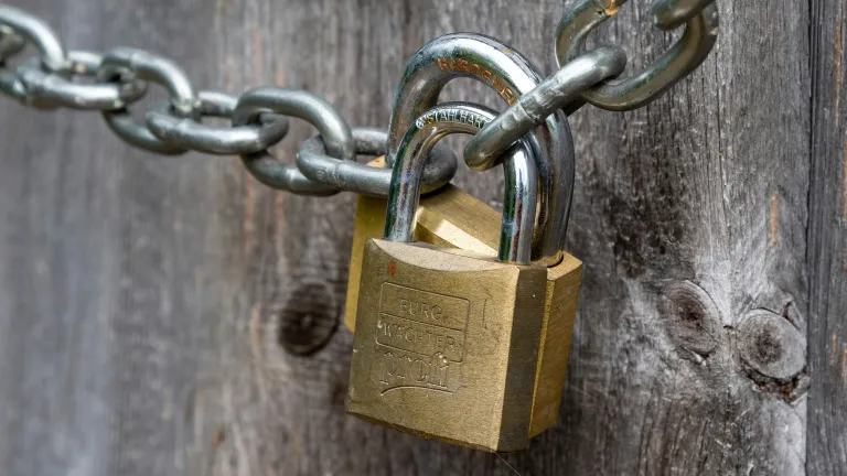 Locks on a chain in front of wooden door