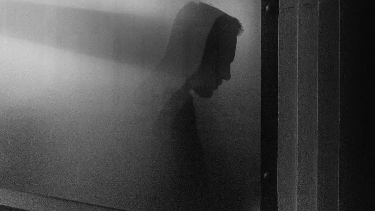 Shadow of a man against a gray wall
