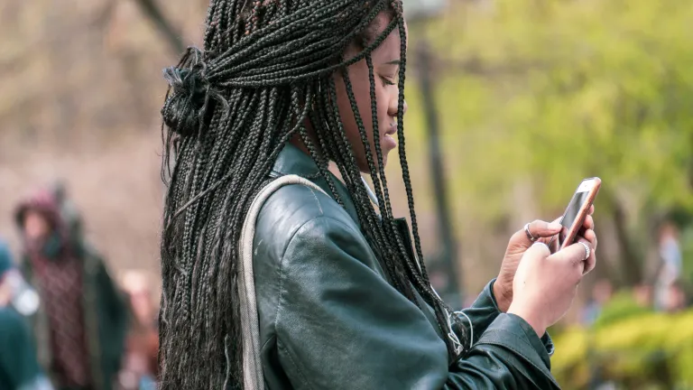 Finding direction in the selection of a career can be challenging for many young adults. a woman looking at her smartphone