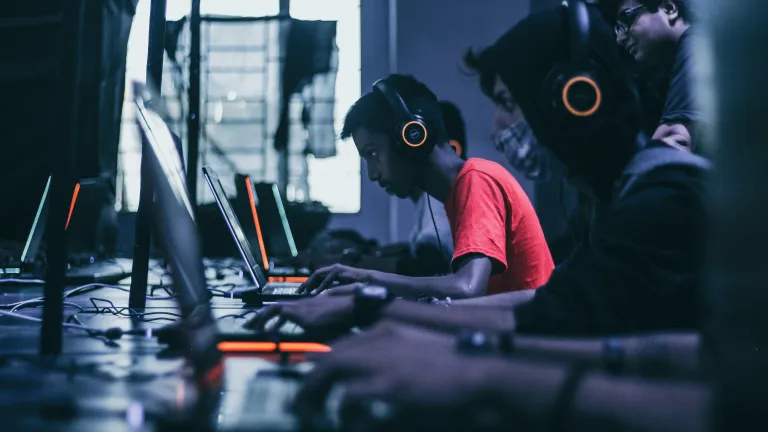 People staring at monitor screens playing video games.