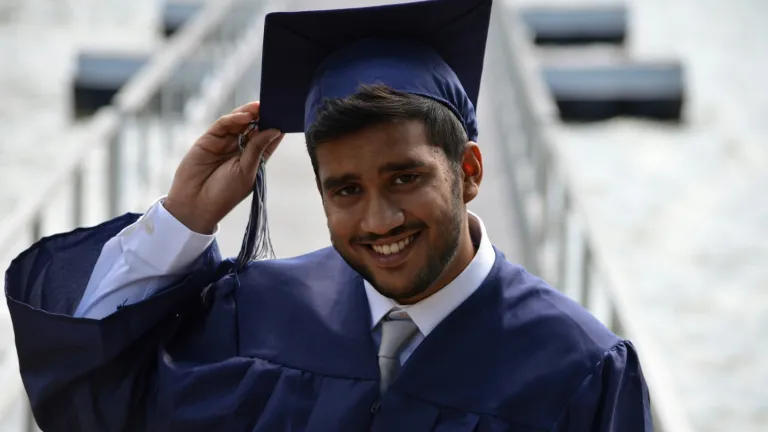 a man wearing a graduation cap and gown