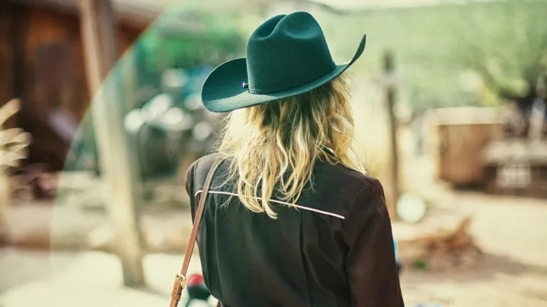 a woman wearing a cowgirl hat