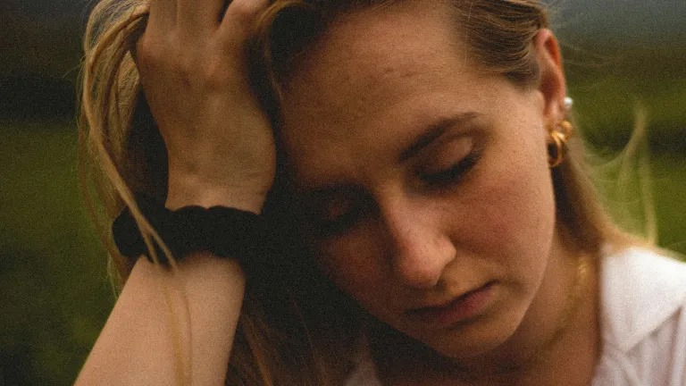 A woman leaning on her hand.