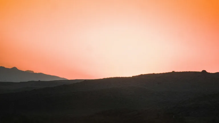 A sunset over a hill.