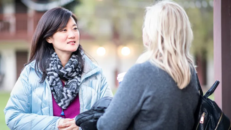 two women having a discussion outside