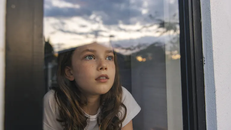 True discipleship means learning to patiently “wait on the Lord,” like a little child eagerly looking out the window in hope and trust, confident that in “God’s seconds,” His perfect timing will always arrive. A little girl looking out the window.