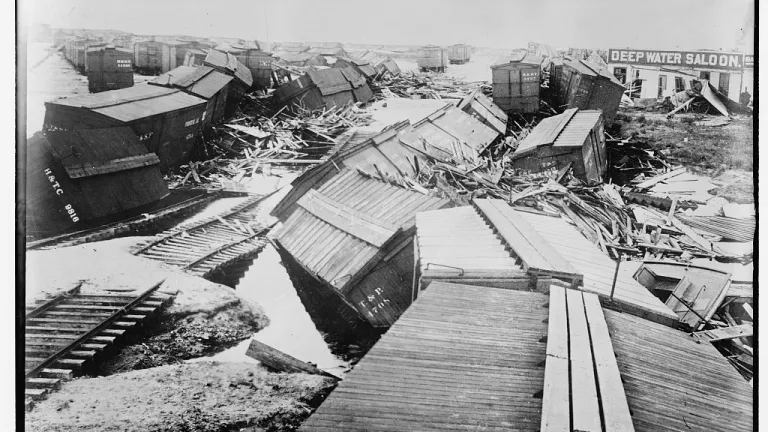 Around 8,000 people perished in the 1900 Galveston hurricane and subsequent flooding. debris in black and white