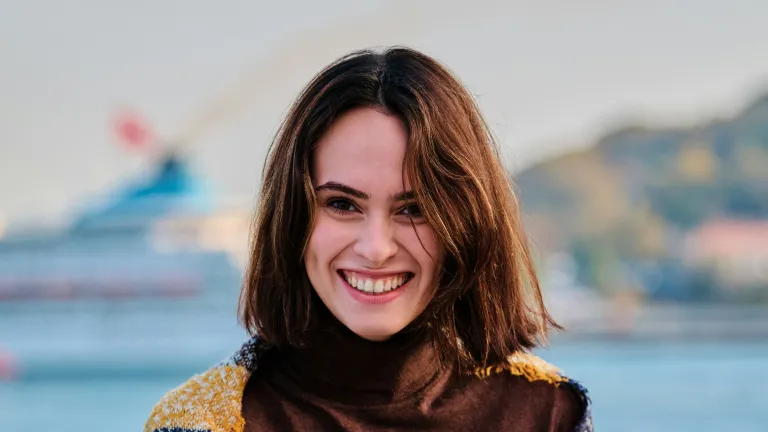 What does God have to say about womanhood? a smiling woman with a body of water in the background