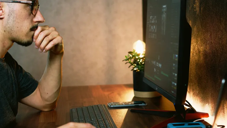 a man looking at a computer screen