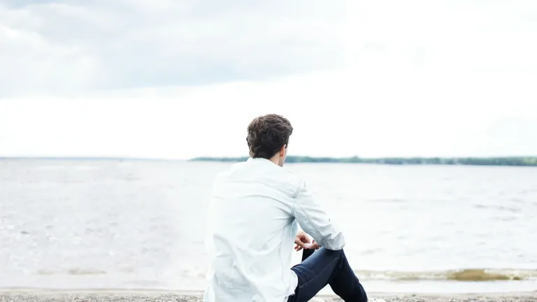 a man sitting on the beach