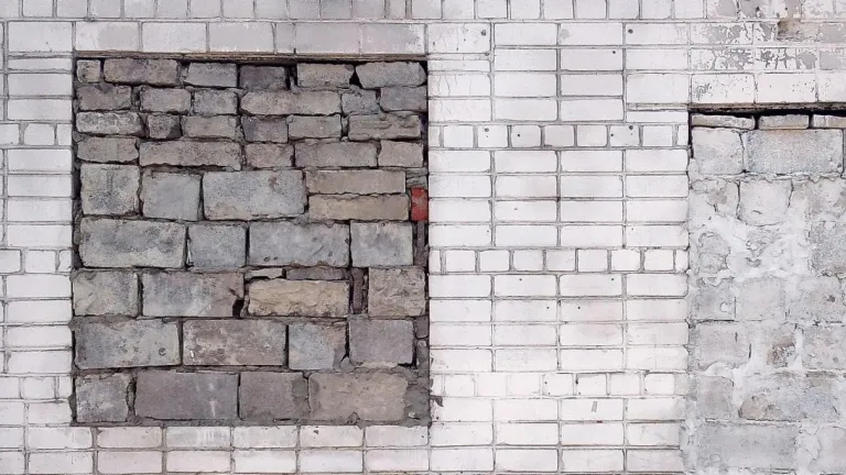 a brick wall with patches made of brick