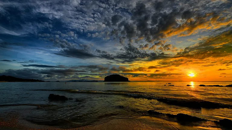 a sunset sky over the beach