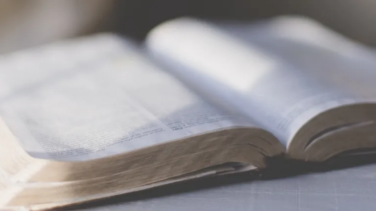 An open Bible on a table.
