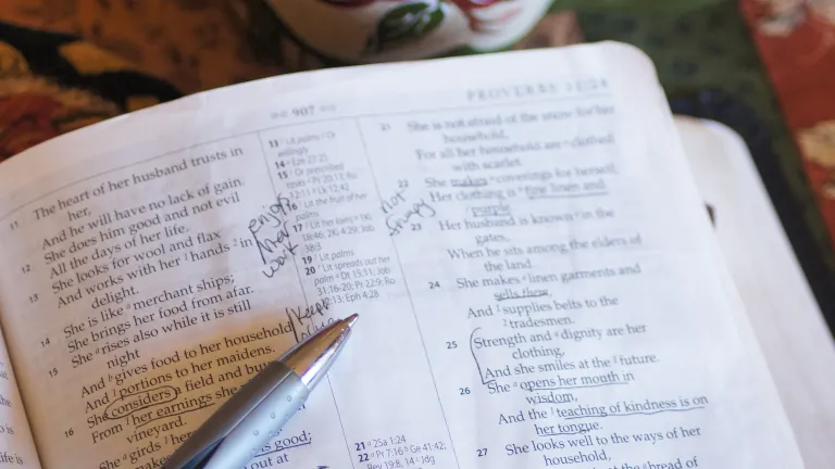 You might be surprised at just how up-to-date the advice of an ancient king can be. A Bible open to Proverbs 31 with notes underlining words in the scriptures.