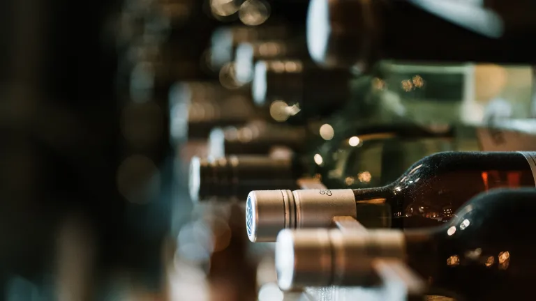 The problem of alcoholism thrives in an atmosphere where knowledge and awareness are lacking. a row of wine bottles on their sides