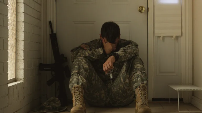 None of us want to become victims of spiritual battle fatigue. a soldier wearing camo sitting on the floor inside a house with his head in his hand