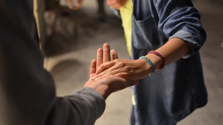Our willingness and our efforts to forgive others are a pivotal part of the process of emotional healing. two people standing with one person's hand in the other's outstretched palm