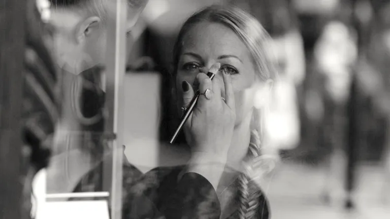 Our society places a high emphasis on the physical aspect of beauty and neglects the other elements that really make a woman totally beautiful. A woman getting makeup put on her in a salon.