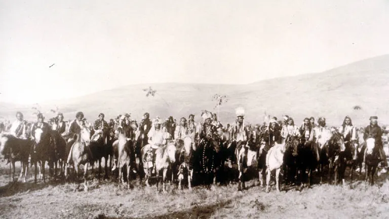 Joseph (c. 1840-1904), chief of the Nez Percé. He led his tribe in successful resistance to the settlers in 1877, but finally decided to surrender to save his people. A large group of men on horseback with mountains in the background. In the front center of the group can be seen Chief Joseph, White Bird and Looking Glass.