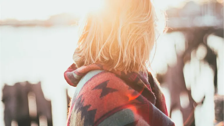 A woman with sunlight behind her.