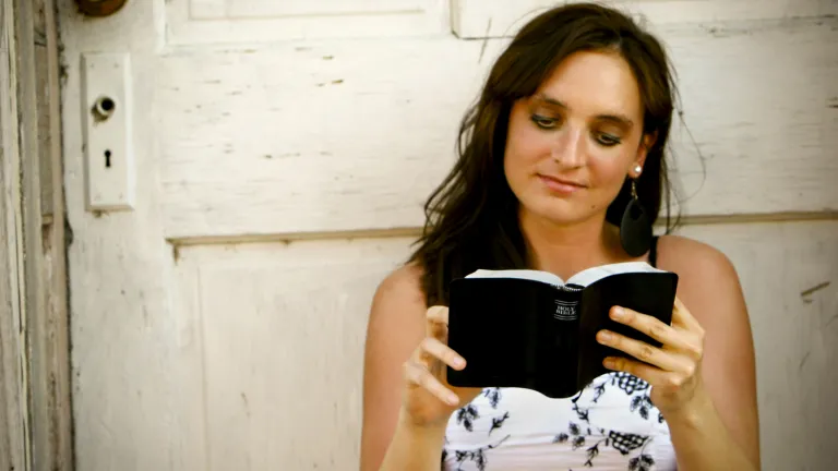 A young woman reading a Bible.