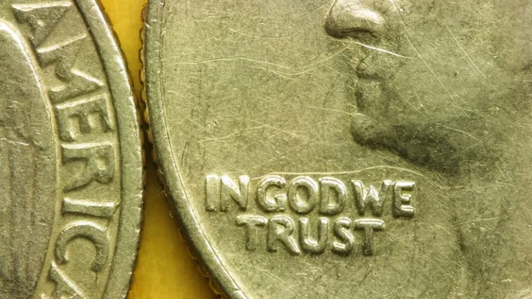 Close up of United States quarter displaying the phrase "In God We Trust".