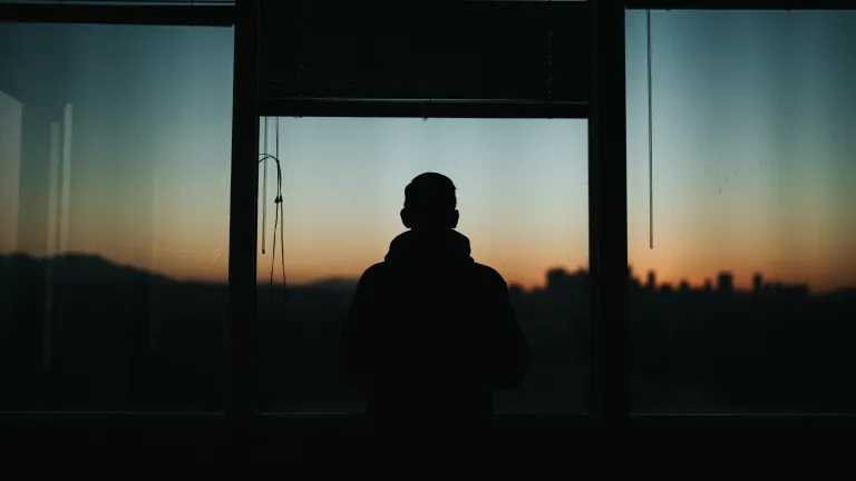 God has a future work for these two servants just as much as He has personally called you to honor Him in this current troubled age of man.  A silhouette of man standing by a window.