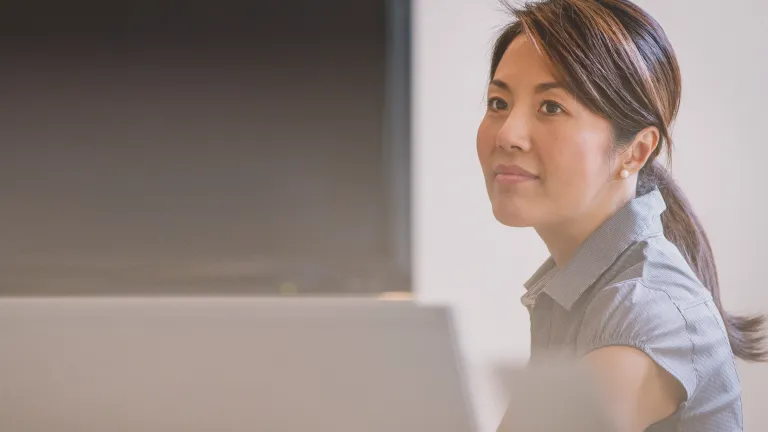 A woman sitting a table.