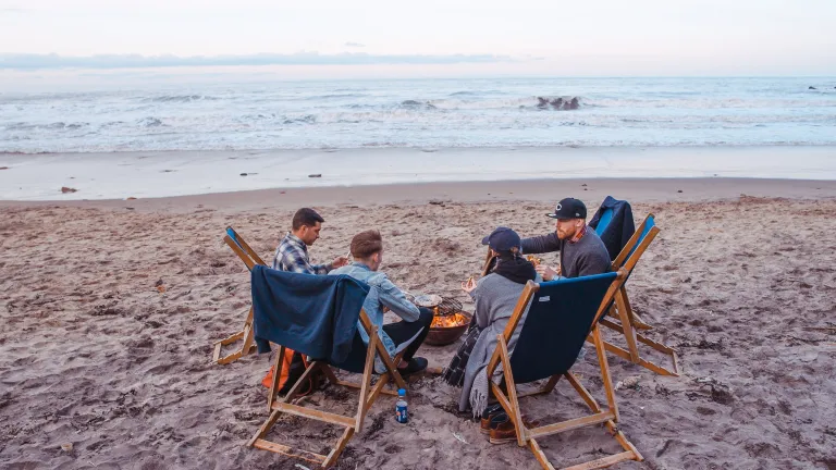 Let's rededicate ourselves to rekindling the fires of our faithfulness to God's word, His way of life and to our fellowship with our brethren. A group of friends around a campfire on the beach.