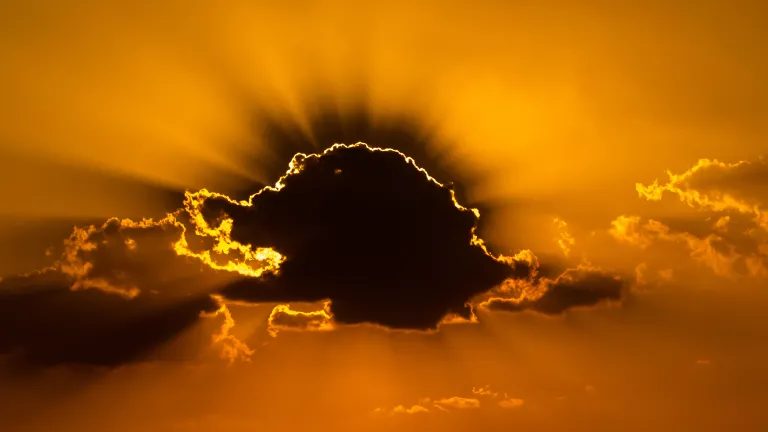 A time is coming when God will intervene by sending Jesus Christ to rule over the nations and save us from ourselves. Sun rays coming through the clouds.