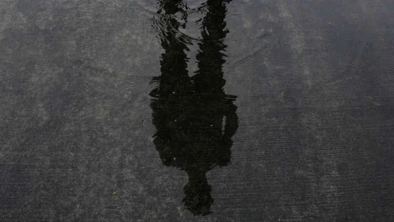 How will the mark of the beast affect people as the time of the end draws near? A person's shadow in shallow pool of water.