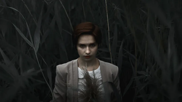A woman standing in the dark.
