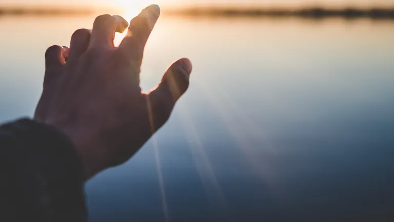The laying on of hands after baptism has signified the actual moment of the receiving of the Holy Spirit and the setting apart of a convert as a child of God. A hand reaching out over water.