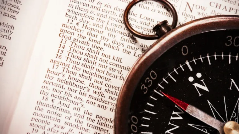 Compass on top of the Bible.