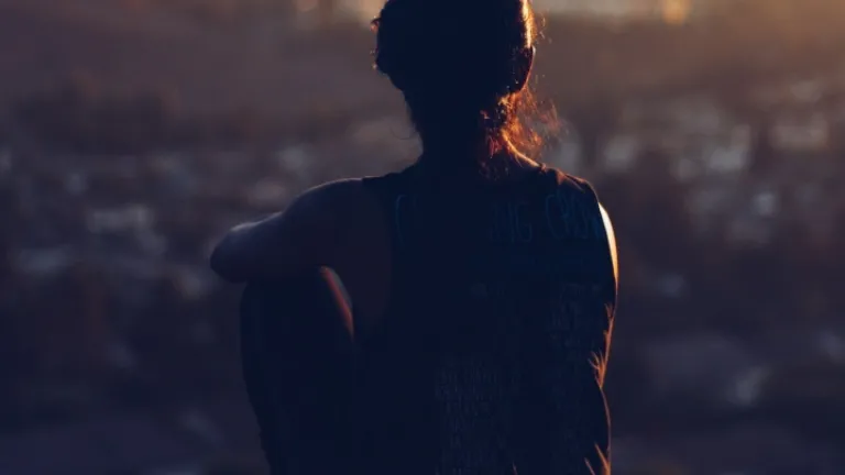 A young woman sitting by herself.